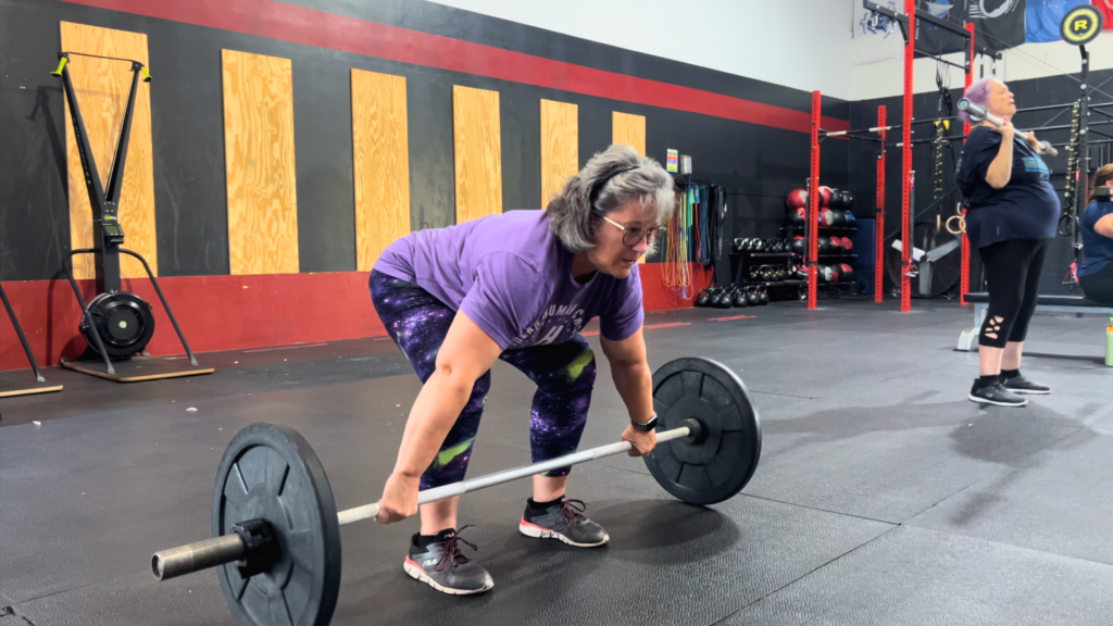 Donna deadlifting at Modern Human CrossFit in Daytona Beach, FL after her knee replacement.